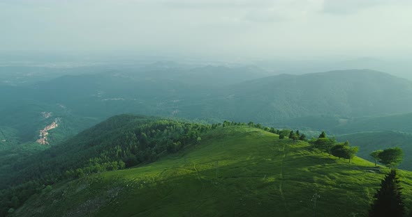 Aerial View of a Beautiful Green Valley with Surrounding Mountains