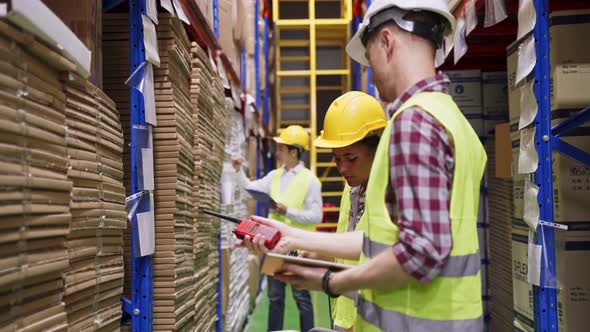 Group of diversity people worker wear safety helmet and mask working in warehouse plant factory.