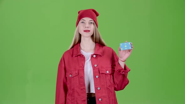 Teen Raises a Blue Card and Shows a Thumbs Up. Green Screen