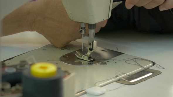 Close up of hands sewing