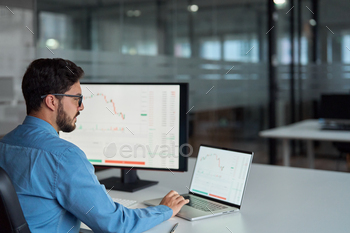 Business man trader broker investor using computer analyzing stock market chart.