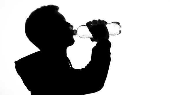 Male Runner Shadow Drinking Water From Bottle, Healthy Lifestyle, Nutrition