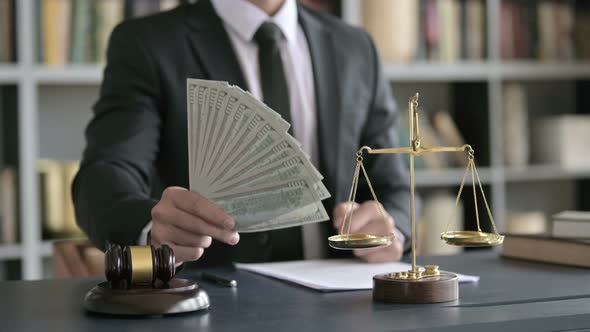 Close Up Shoot of Lawyer Hand Holding Money in Court Room