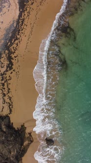 Vertical Overhead Shot of Colora Beach with Crashing Waves in Puerto Rico