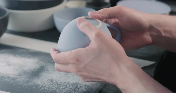 Slow Motion Man Hands Polishing Bottom of Blue Ceramic Cup