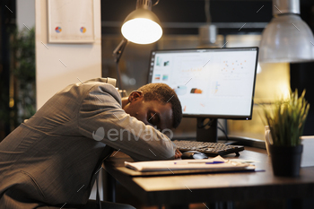 fice after working overtime at investment plan. Manager falling asleep alone in company after finishing management work. Business concept