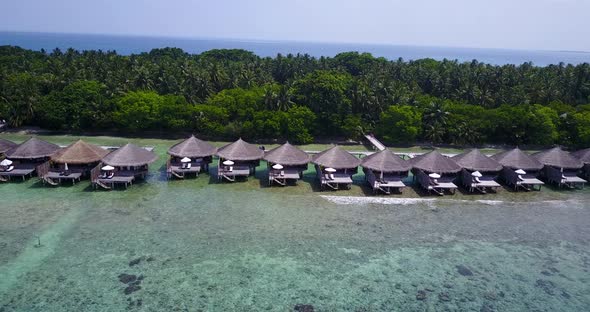 Beautiful overhead tourism shot of a sunshine white sandy paradise beach and aqua blue ocean backgro