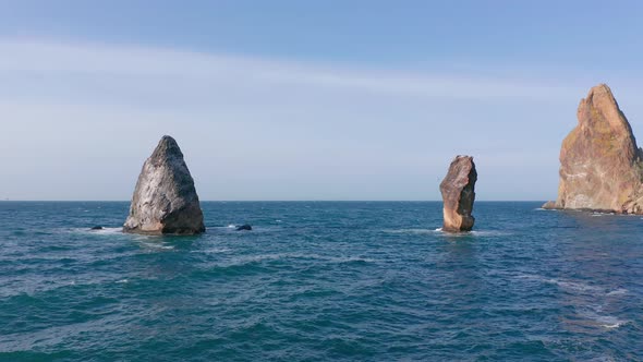 Fly Above Sea Surface Between Rocks