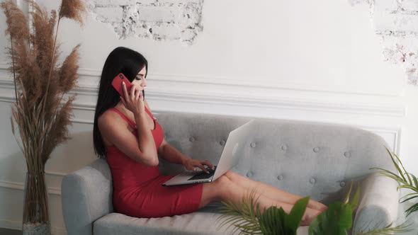 Adorable Young Caucasian Brunette Woman in a Red Dress Answers the Call