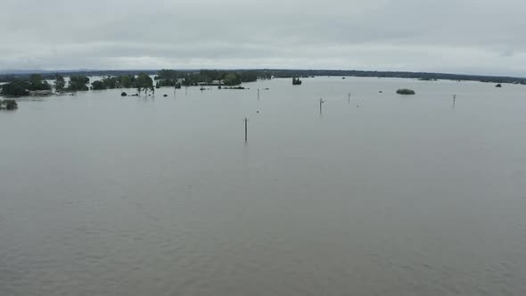 Fully submerged street aerial view with only the telegraph poles showing above the flood