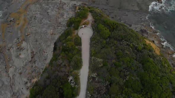 A birds eye view aerial shot of people at a look out at eagles nest on Bass coast Victoria.