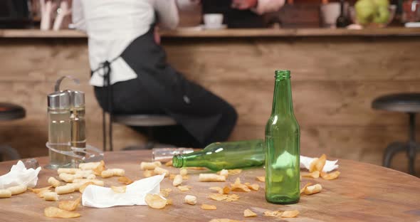 Potato Chips, Napkins and Corn Cheese Puffs on a Wooden Table