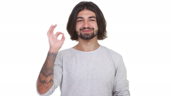 Caucasian Guy with Long Hair Showing Ok Isolated Over White Background