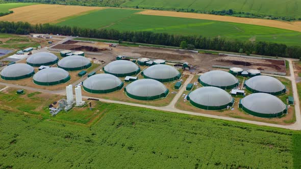 Production of sustainable fuel called bio gas. New factory in field. Video from above.