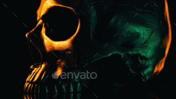 Bronze human skull rotates on black background. Exploring death, gothic theme.