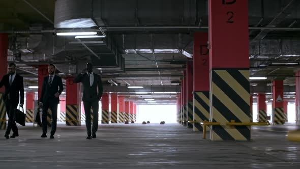 Businessmen Walking in Underground Parking Lot