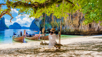  Lading Krabi Thailand part of the Koh Hong Islands in Thailand. beautiful beach with limestone cliffs and longtail boats on a sunny day
