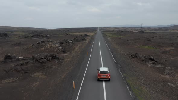 Drone View 4X4 Vehicle Driving Highway in Remote Rocky Desert in Icelandic Countryside