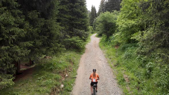 Man Ride Bicycle on the Mountain Road Aerial Shot