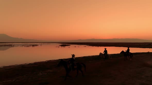 Cowboys With Horses at Sunrise