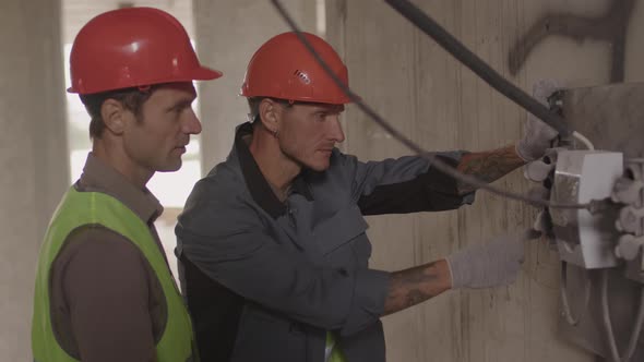 Workers Checking Electrical Panel