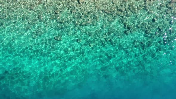 Waves and azure water as a background. View from drone at the ocean surface.