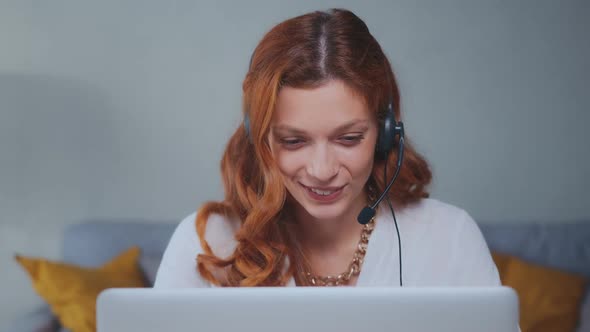 Caucasian Woman Office Worker with Wired Headset Making Video Call in Laptop