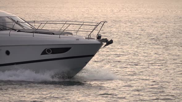 Close up view of luxury white motor yacht sailing in the sea, ocean on sunset. Slow motion