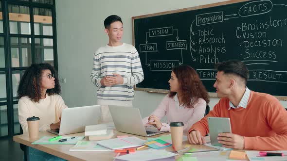 Four Multiethnic Smiling Happy Colleagues Working Together in Modern Office