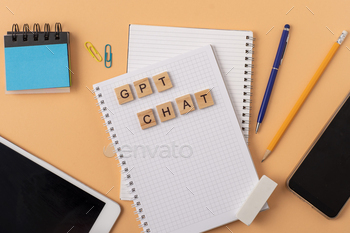 Work and study with the help of a chat bot. Words in wooden letters. Work table with open notebook.