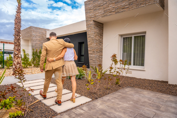 Couple walking along the entrance of a new home