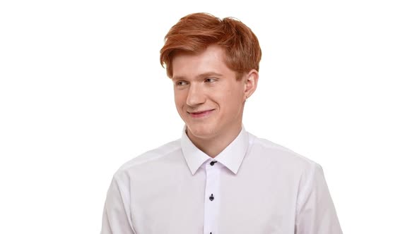 Shy Handsome Caucasian Foxy Young Man Standing on White Background Looking at Camera with