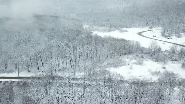 Drones Eye View  Winding Road From the High Mountain Pass in Winter