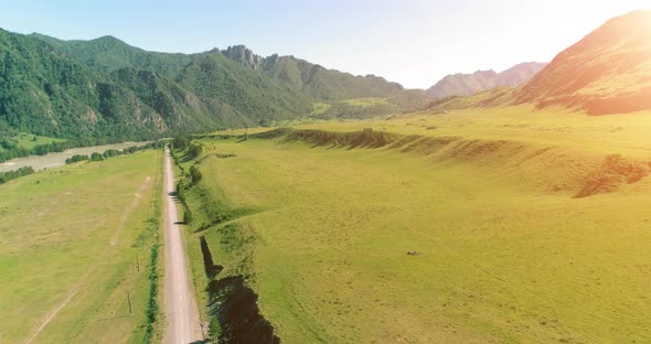 Aerial Rural Mountain Road and Meadow at Sunny Summer Morning