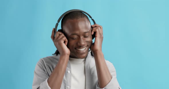African American Guy Wearing Headphones Enjoying Music