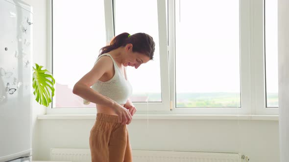 Slim Surprised Happy Woman Body in Big Pants