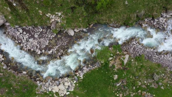 Aerial View of Natural Winding River in Green grass field