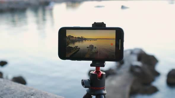 Close Up Smartphone Recording Time Lapse of Sunrise or Sunset at the Sea Coast