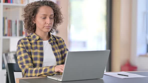 Mixed Race Woman with Laptop Showing No Gesture Disapprove