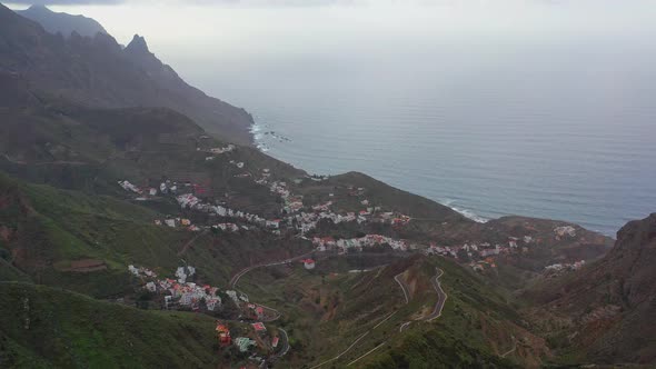 A small mountain village on the atlantic coast of the Tenerife island with the sharp distant mountai