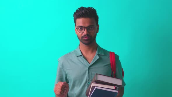 Indian Student Man Feeling Happy Looking at Camera Wear Eye Glasses and Orange Backpack and Saying
