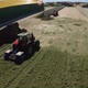 Copter flying around tractors in a silo on a farm - VideoHive Item for Sale