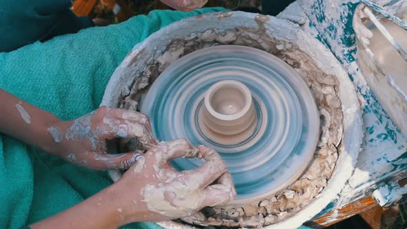 Potter's Hands Work with Clay on a Potter's Wheel