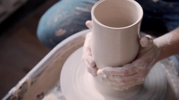 Sculptor Working with Raw and Wet Clay in Workshop Room