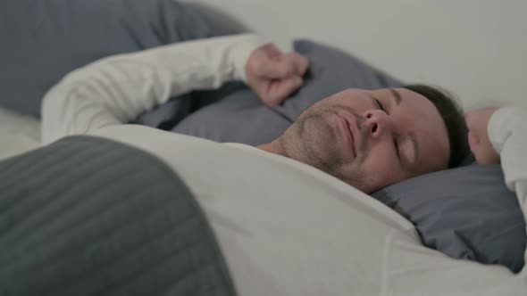 Close Up Casual Man Waking Up From Sleep in Bed