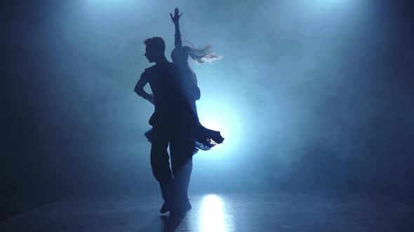 Graceful Couple of Latino Dancers Posing in Smoky, Slow Motion