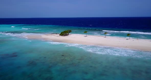 Beautiful drone tourism shot of a sunshine white sandy paradise beach and aqua turquoise water backg