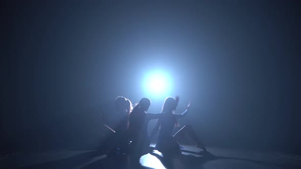 Three Silhouettes of Professional Ballerinas Dancing Elements of Modern Ballet.