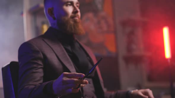 Handsome Male Barber Checking Scissors for Cutting Hair Look at Them and Examine