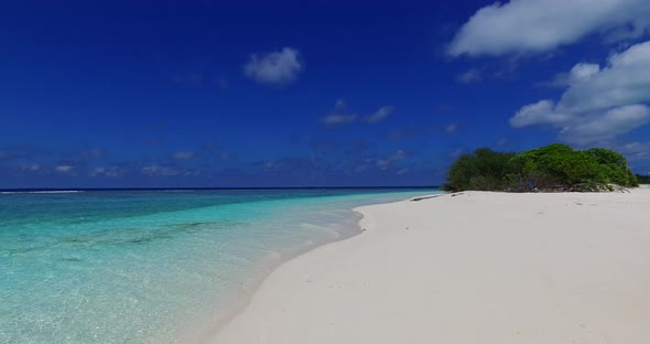 Daytime drone abstract view of a white sand paradise beach and aqua blue water background in high re